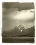 The tip of the Grand Teton is capped by a storm cloud passing through the park.