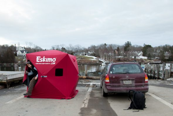 Mark Dawson exits his portable darkroom along the Rockport Harbor. Dawson is making tintypes of some friends with Rockport as the backdrop.