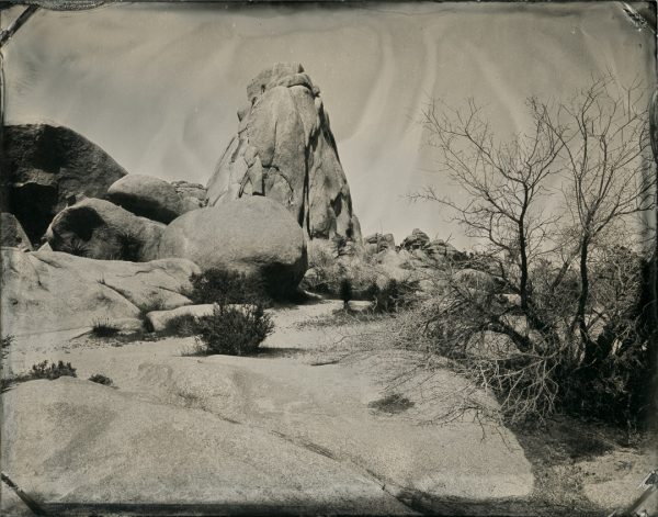 Joshua Tree National Park, California. If you look closely there are some people rock climbing near the top left side of the tall rock.