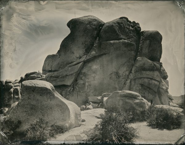 Joshua Tree National Park, California. If you look closely there are some people rock climbing on the left side of the outcrop.